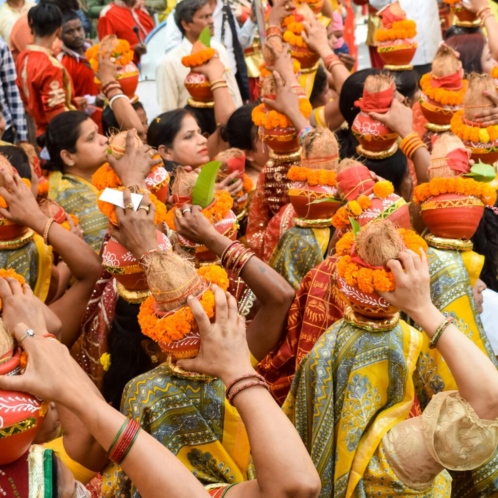 Bonalu Colorful and festive gathering of women in traditional attire, carrying decorated vases.