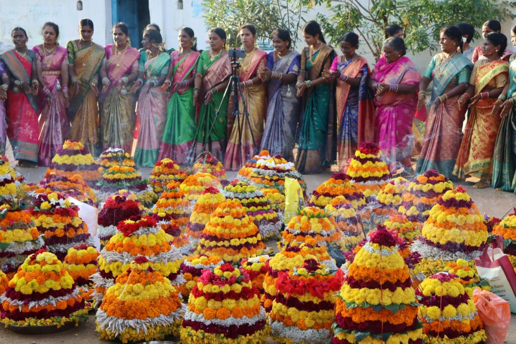 Bathukamma Festival Vibrant display of women celebrating the Bathukamma festival with colorful flower arrangements in India.