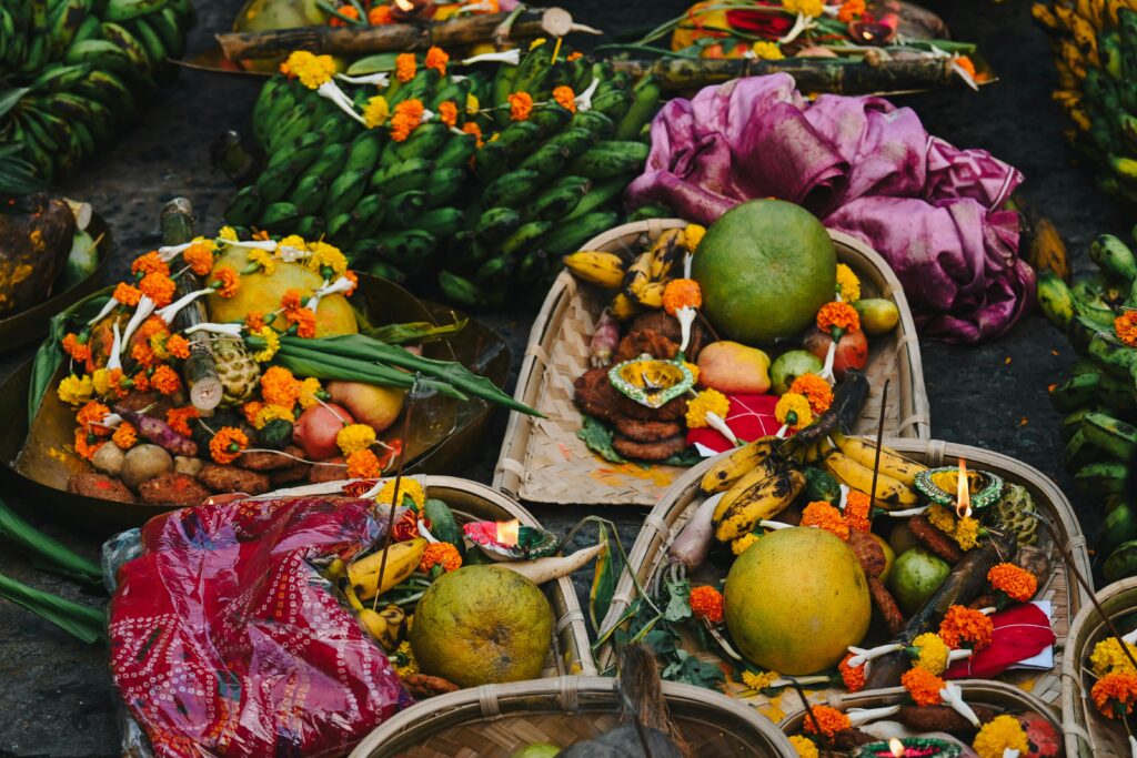 Colorful offering baskets featuring fruits and flowers at a Hindu festival in Bihar, India.
