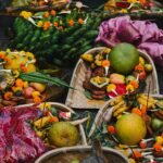 Colorful offering baskets featuring fruits and flowers at a Hindu festival in Bihar, India.