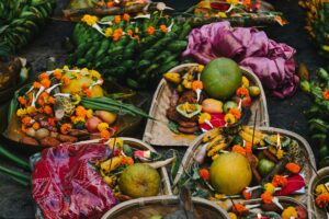 Colorful offering baskets featuring fruits and flowers at a Hindu festival in Bihar, India.